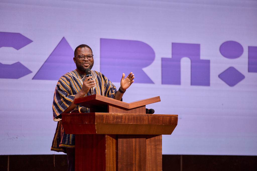 Speaker on stage at a youth event in Ghana